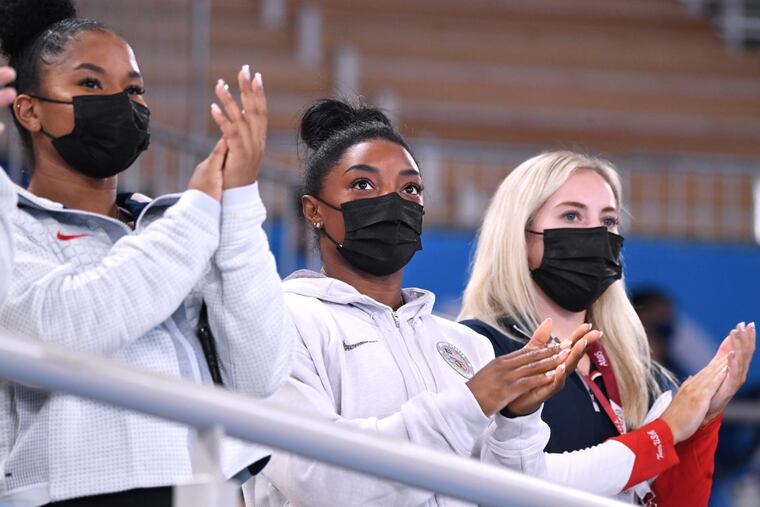 Simone Biles, center, has cheered her teammates on from the stands for the last few days. She'll be back in action on Tuesday.