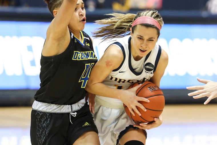 Delaware Blue Hens guard Paris McBride (4) fouls Drexel Dragons guard Hannah Nihill (12).