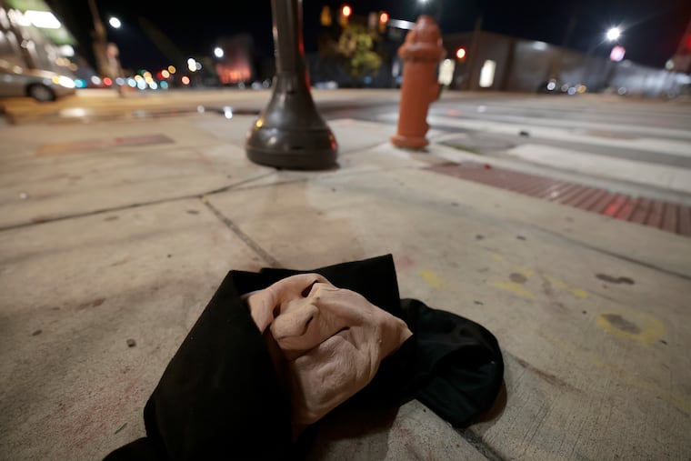 A Halloween mask left behind at the scene after six people were struck by gunfire outside the Trilogy nightclub at Sixth and Spring Garden Streets in Philadephia on Sunday.