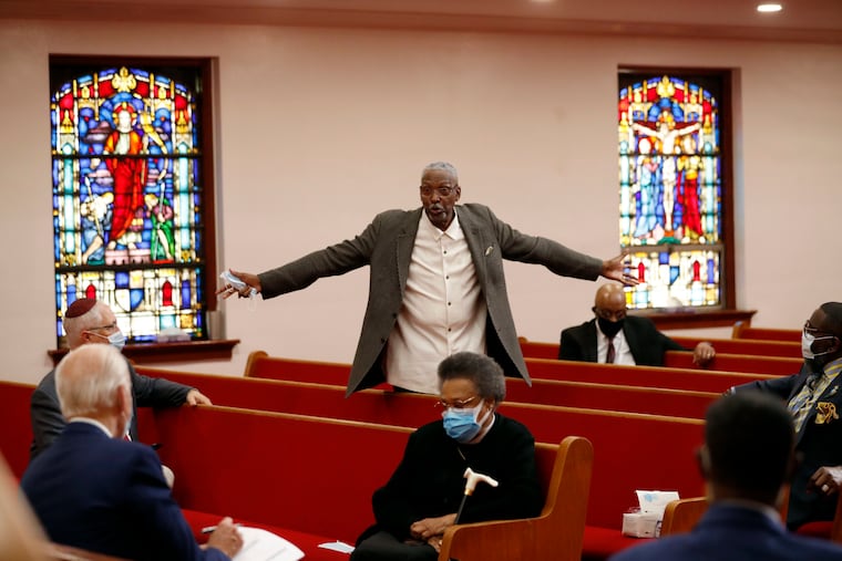 Bishop Thomas Wesley Weeks stands as he speaks to Joe Biden, left, at Bethel AME Church in Wilmington.