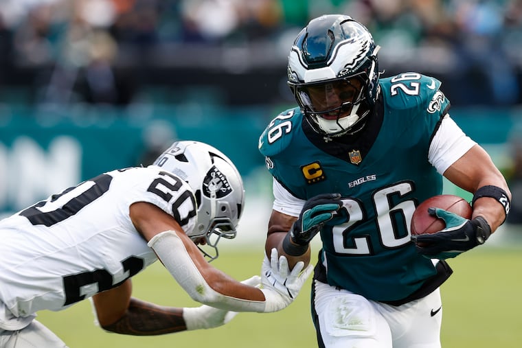 Eagles running back Saquon Barkley runs for a first down against Las Vegas Raiders safety Isaiah Pola-Mao in the third quarter on Sunday.