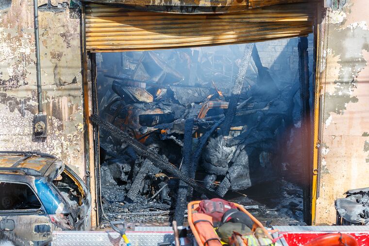 The charred interior of Van's Exclusive Auto in Frankford, the scene of a four-alarm fire overnight that killed the owner's dog and destroyed the auto body-repair business.