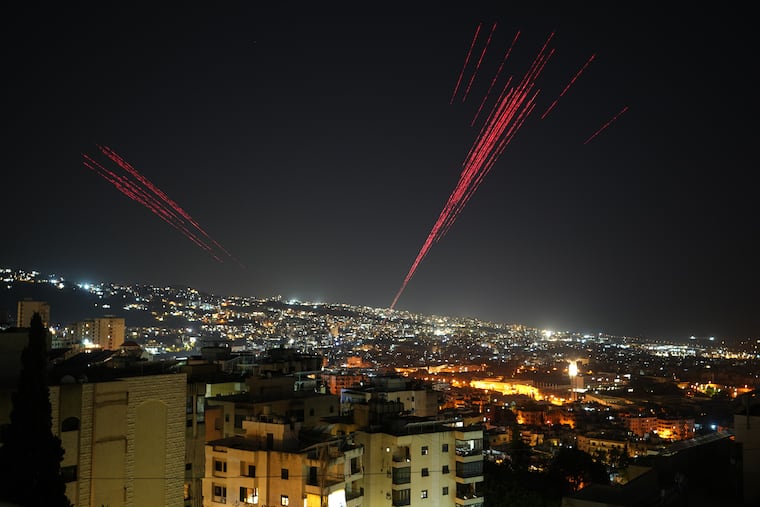 Tracer rounds illuminate the night sky early Friday in Beirut as people fire live ammunition and fireworks into the air to celebrate the start of a ceasefire between Israel and Lebanon.