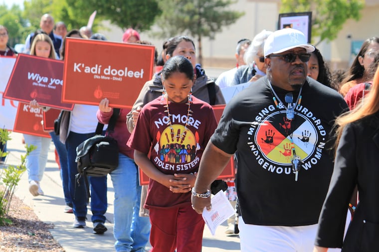 Tize W. Clark (right) and his son, Zion Clark, participate in a walk to honor Native American and Indigenous relatives who have gone missing or have been killed as Missing and Murdered Indigenous Persons Awareness Day is marked in Albuquerque, New Mexico, on May 5, 2025.