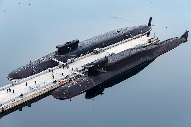 FILE - In this photo released by Russian Defense Ministry Press Service on April 13, 2021, Russian nuclear submarines Prince Vladimir, above, and Yekaterinburg are harbored at a Russian naval base in Gazhiyevo, Kola Peninsula, Russia.