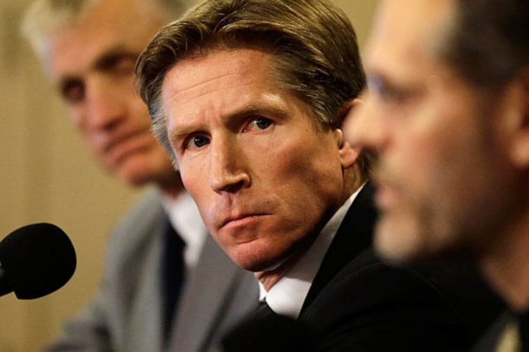 Philadelphia Flyers newly-hired head coach Dave Hakstol, center, and
team president Paul Holmgren, left, look on as team general manager
Ron Hextall, right, speaks during a news conference, Monday, May 18,
2015, in Philadelphia. (Matt Slocum/AP)