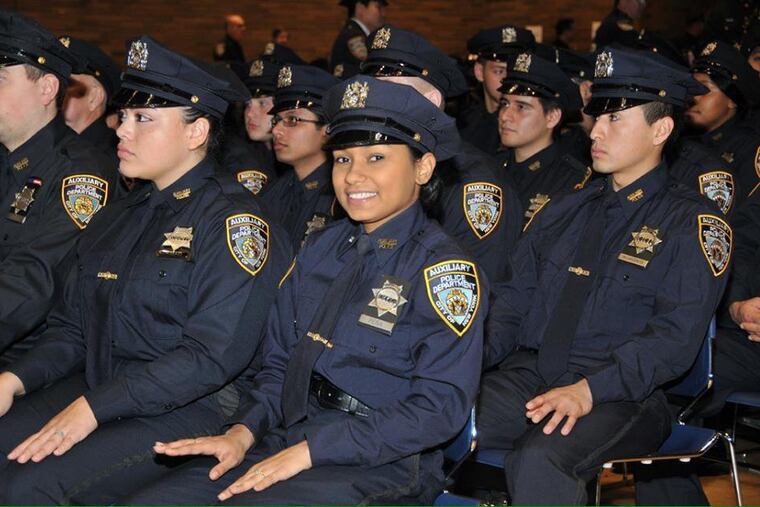 New York City Police Department auxiliary officers are shown at a graduation ceremony after training.