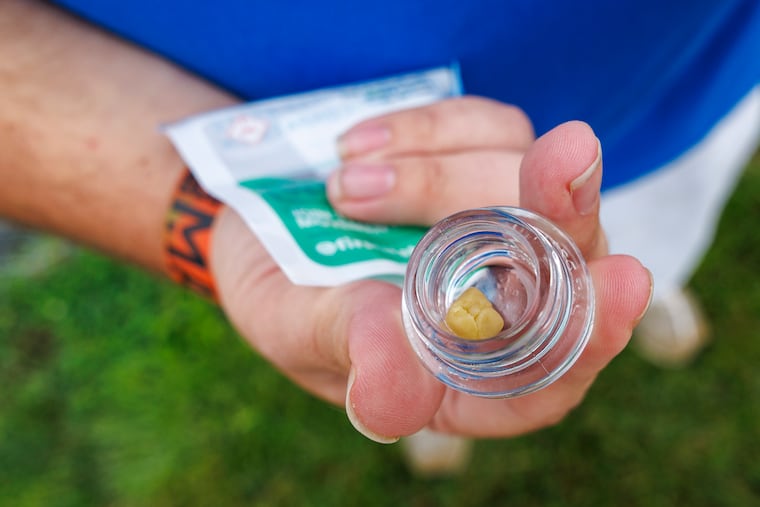 Matthew Fisher holds the concentrated form of cannabis, called live rosin, purchased on the first day of recreational cannabis sales at Thrive Dispensary in Wilmington, on Aug. 1, 2025. This strain of cannabis is called "Critical Bilbo."