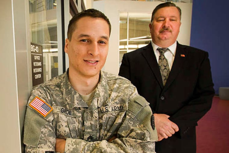 Eduardo Grob, an Army veteran from Brazil who graduated from Community College of Philadelphia on Saturday, with his mentor Steve Bachovin. ALEJANDRO A. ALVAREZ / STAFF PHOTOGRAPHER