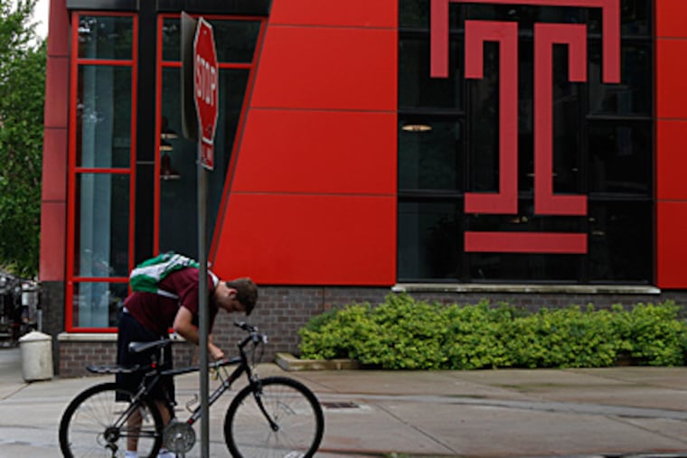 Temple student Tyler Kern, 20, locks his bike before going into the Howard Gittis Student Center. Kern, a junior majoring in accounting, is attending summer school. ( Michael S. Wirtz / Staff Photographer )