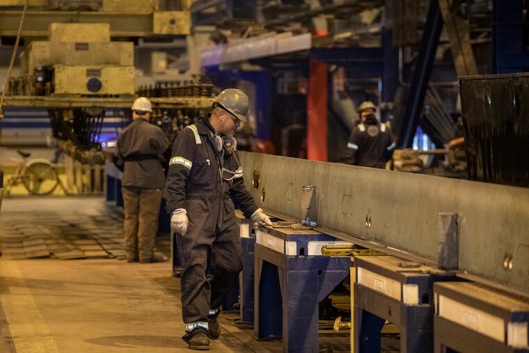 Workers are shown at the sheet metal plant in 2021 at the Philly Shipyard in Philadelphia. The West Philadelphia Skills Initiative's workforce development program placed a group of new recruits in jobs as laborers at the Philly Shipyard. These are the kinds of middle-wage jobs that a 2022 Pew Charitable Trusts report said are vital to an inclusive economic recovery from the pandemic.
