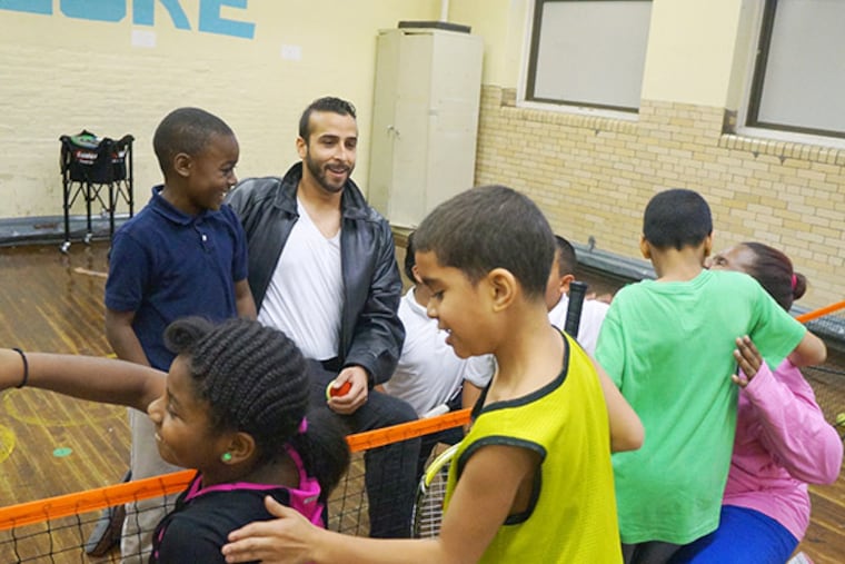 Jonathan Rosado, beloved Hunting Park tennis coach, with his students at McClure Elementary School. His slaying on Dec. 20 has left the kids "inconsolable." (Legacy Youth Tennis photo)