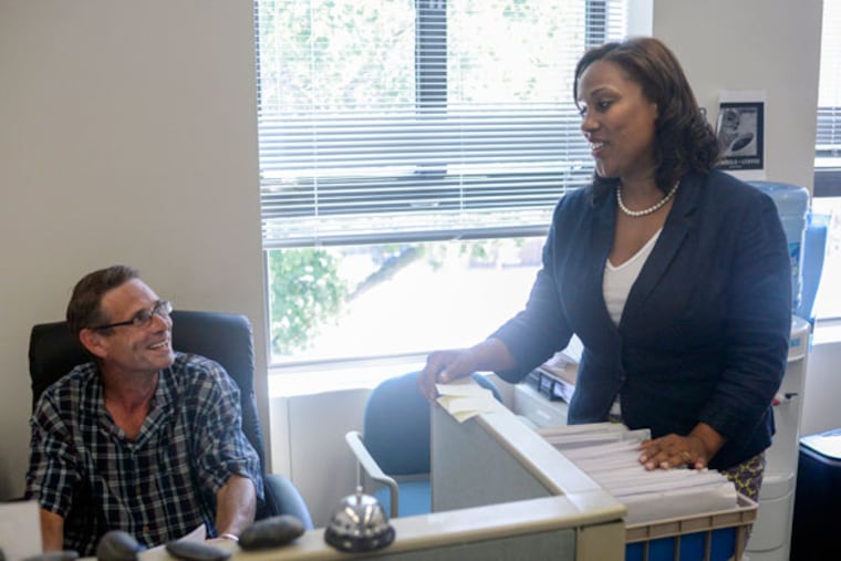 Keir Bradford-Grey talks with Bill Gordon during her last day as chief public defender in Montgomery County, at the county courthouse. (BEN MIKESELL / Staff Photographer)