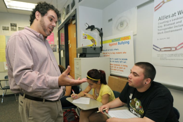 North Penn High School social studies teacher David Hall talks with student Darin Wible, 18. Hall received a "Teacher as Hero" award from the National Liberty Museum in Philadelphia. (April Saul / Staff Photographer)