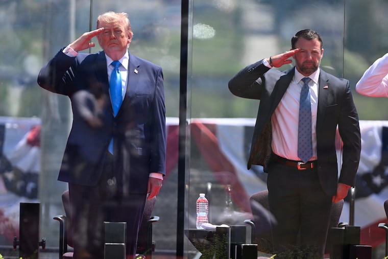 President Donald Trump (left) and Secretary of Homeland Security Markwayne Mullin salute at the start of the commencement ceremony at the U.S. Coast Guard Academy in New London, Conn., Wednesday, May 20, 2026.