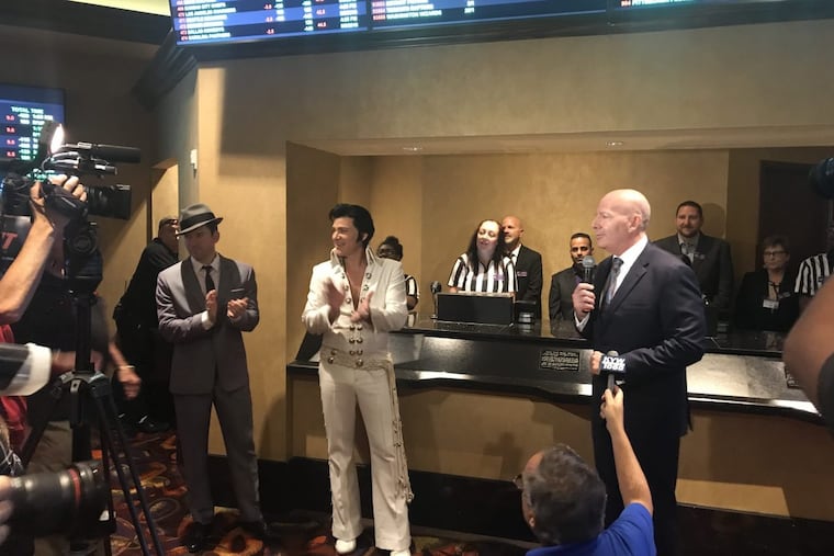 Frank Sinatra and Elvis Presley impersonators help Caesars regional president Kevin Ortzman open the sportsbook at Harrah's in Atlantic City on Aug. 1, 2018.
