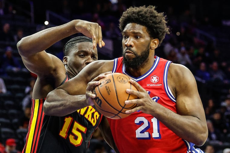 Sixers star Joel Embiid drives against the Hawks' Clint Capela in the first quarter Friday.