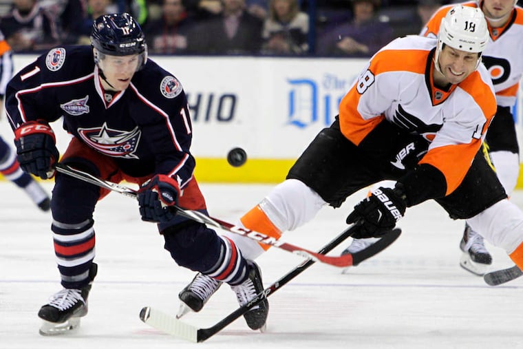 The Flyers' R.J. Umberger (right) chases the puck with Columbus' Matt Calvert. The Flyers surrendered a 3-1 lead in the third period on the way to the loss.