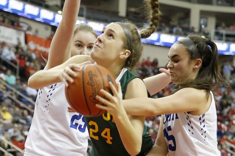 Archbishop Wood High's Katie May drives to the basket against Trinity High's Alayna Cappelli (right) and Rachel Lemons (left) during the PIAA 5A girl's basketball championship game on Saturday, March 25, 2017 at the Giant Center in Hershey, PA. YONG KIM / Staff Photographer.