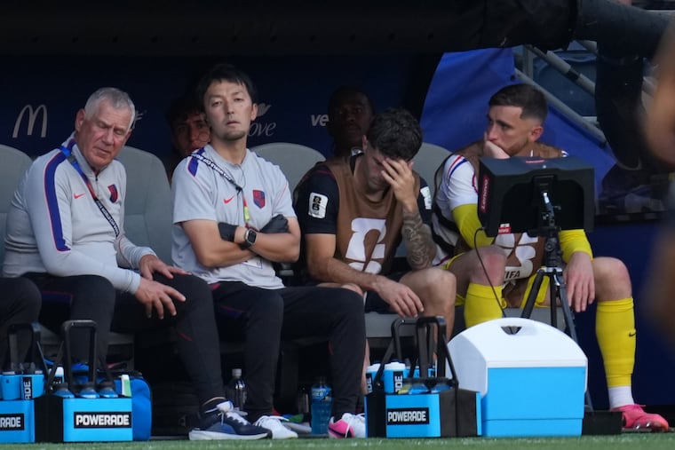 Christian Pulisic (second from right) on the U.S. bench after being subbed out injured in the second half.