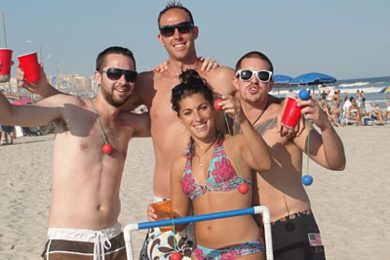 From left: Matt Henneke, Ryan Mahlman, Jenna Gallo and Jarrod Holzman play bolo on the Fredericksburg Avenue Beach in Ventnor. (AMY ROSENBERG / Staff)