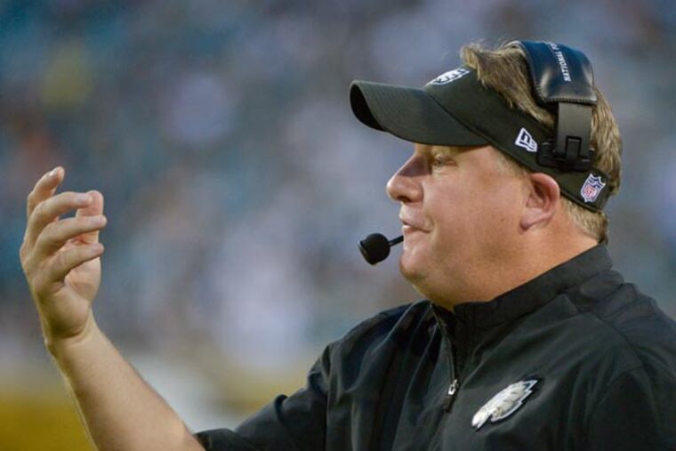 Chip Kelly directs his players against the Jacksonville Jaguars during the first half of an NFL preseason football game, Saturday, Aug. 24, 2013, in Jacksonville, Fla. (Phelan M. Ebenhack/AP)