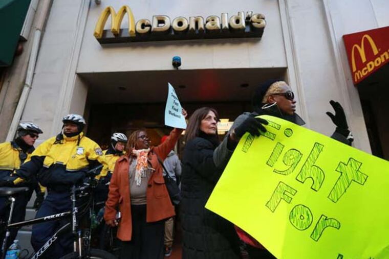 Protesters demonstrate for a higher minimum wage outside a McDonald's restaurant at 17th and Walnut.. ( DAVID SWANSON / Staff Photographer )