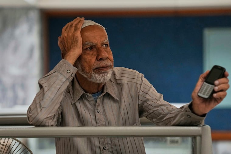 A dejected investor waits to restart trading, which was suspended for an hour following a 5% drop in its main index, at the Pakistan Stock Exchange on Monday, April 7, 2025.