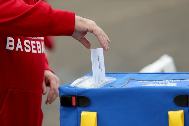 Dan West, of King of Prussia, uses a secure ballot drop box in Norristown on Oct. 13.