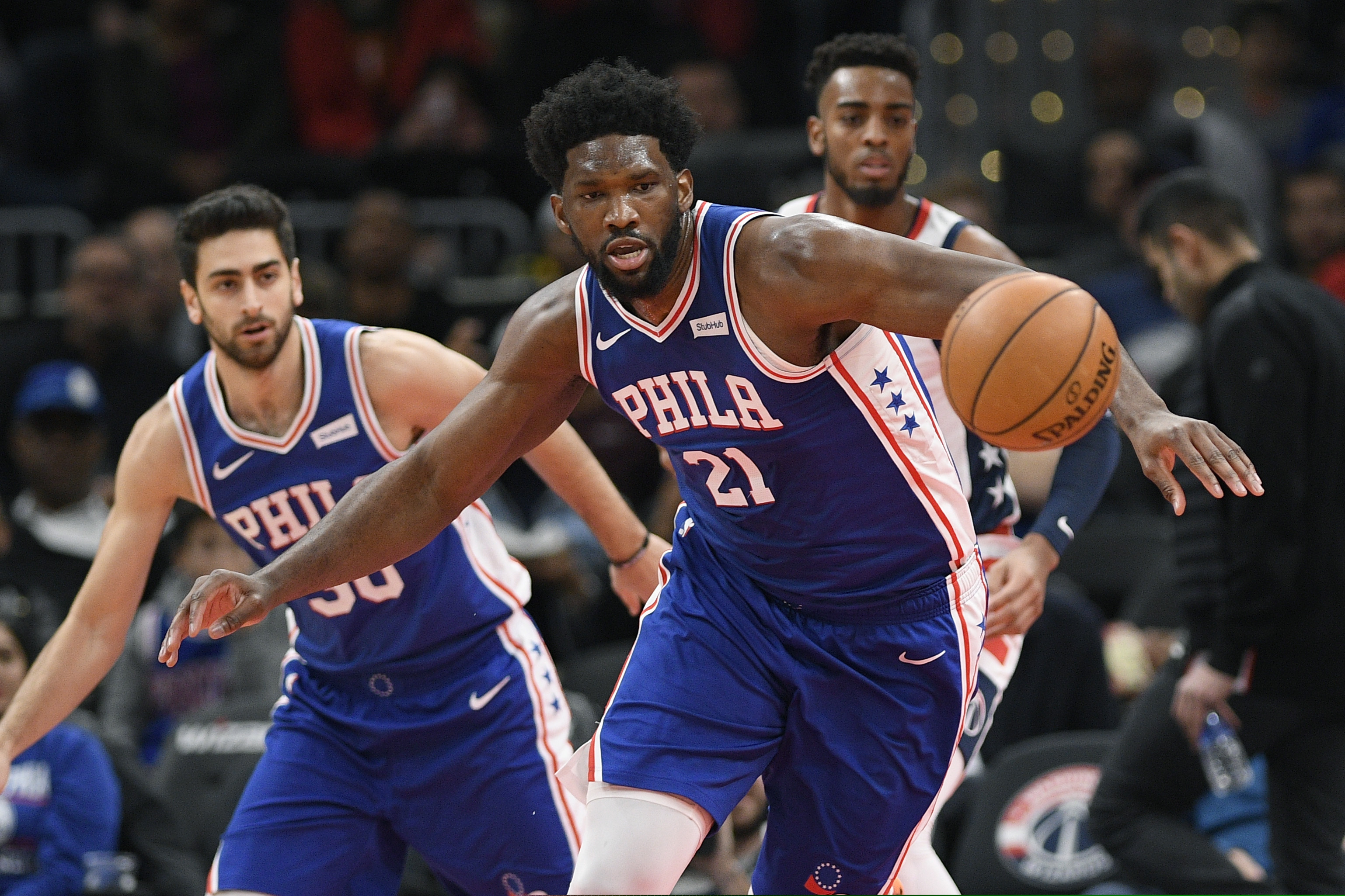 Joel Embiid chases a loose ball in the first half of the Sixers' loss to the Wizards in Washington on Thursday.