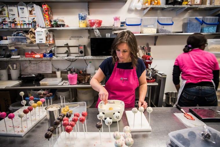 Owner Yael Krigman dips cake pops at her shop Baked by Yael in Washington.