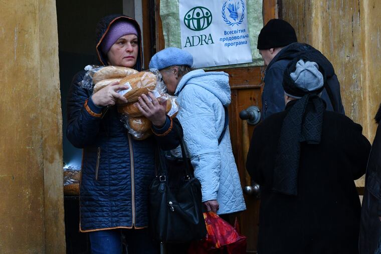 People receive bread at humanitarian aid center in Kramatorsk, Ukraine, on Wednesday.
