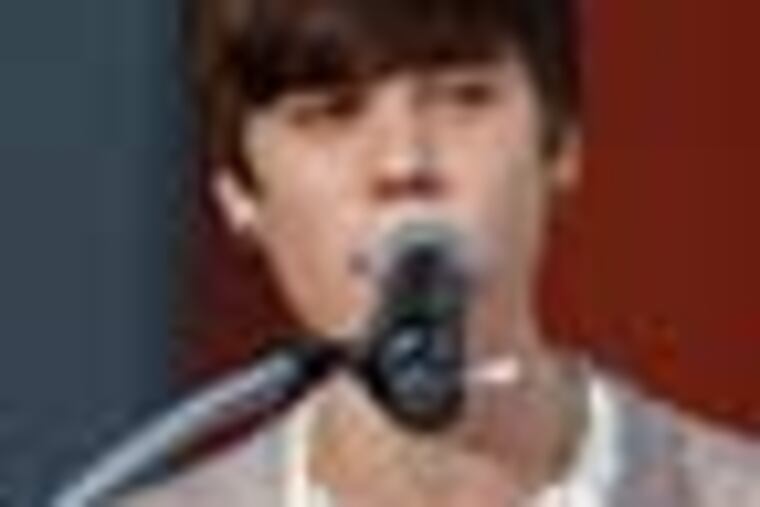 Musician Justin Bieber is seen during a hand and footprint ceremony honoring musician Michael Jackson in front of Grauman's Chinese Theatre in Los Angeles, Thursday, Jan. 26, 2012. The ceremony was held to celebrate the "Michael Jackson The Immortal World Tour" by Cirque du Soleil. (AP Photo/Matt Sayles)