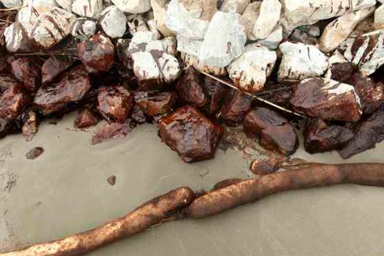 Oil covers rocks at a land bridge built by the Louisiana National Guard to hold back oil on Elmer's Island. An estimated seven million gallons of crude have spilled into the Gulf of Mexicoin the lastfive weeks.