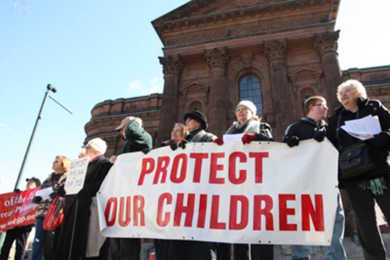 Members of The Voice of the Faithful of Greater Philadelphia held signs and spoke in front of the Basilica of SS. Peter and Paul on Saturday. (Michael Bryant / Staff Photographer)