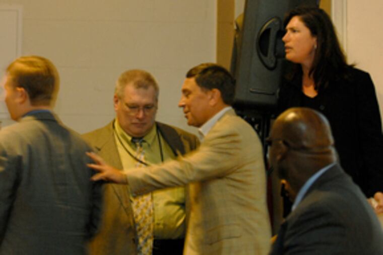 Councilman Frank DiCicco (center) is in the midst of a heated discussion involving Mary Issacson (right), State Rep. Michael O'Brien's chief of staff, at yesterday's casino planning hearing.