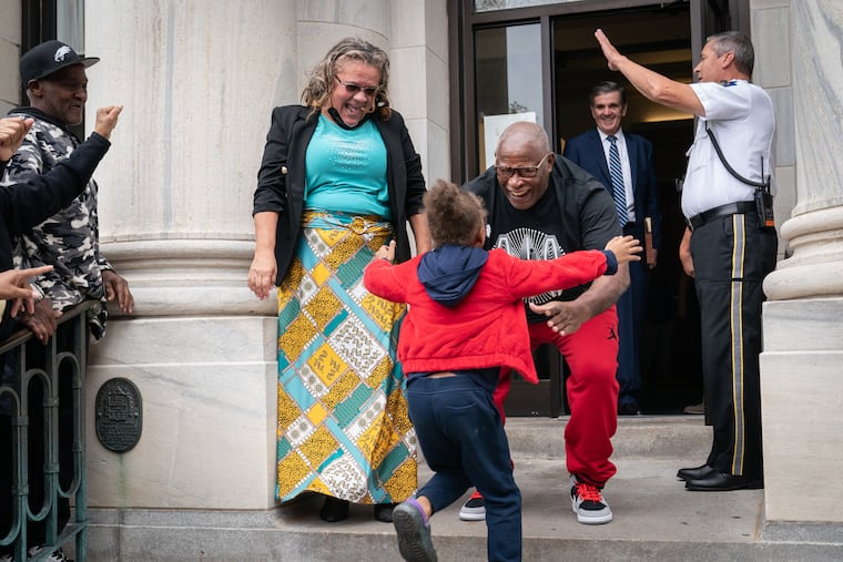 Rosemary Simmons, left, looks on as her husband Leroy Evans, greets his great granddaughter Siniah Butler.