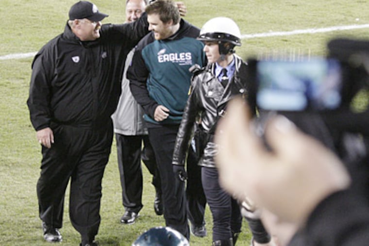 Eagles coach Andy Reid walks with son Garrett after an Eagles win in 2010. (Elizabeth Robertson / Staff File Photo)