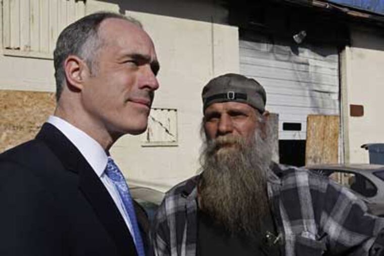 Sen. Robert Casey Jr. (left), talks to Steve Flinn of Steve's Garage after touring the scene of arson fire damage in the 300 block of Fleetwood Street in Coatesville on Monday.(Michael S. Wirtz / Staff Photographer)