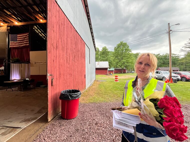 Alice Carpenter, who taught math in the Sullivan County School District, holds flowers she received at the high school graduation on June 7 after announcing her retirement.