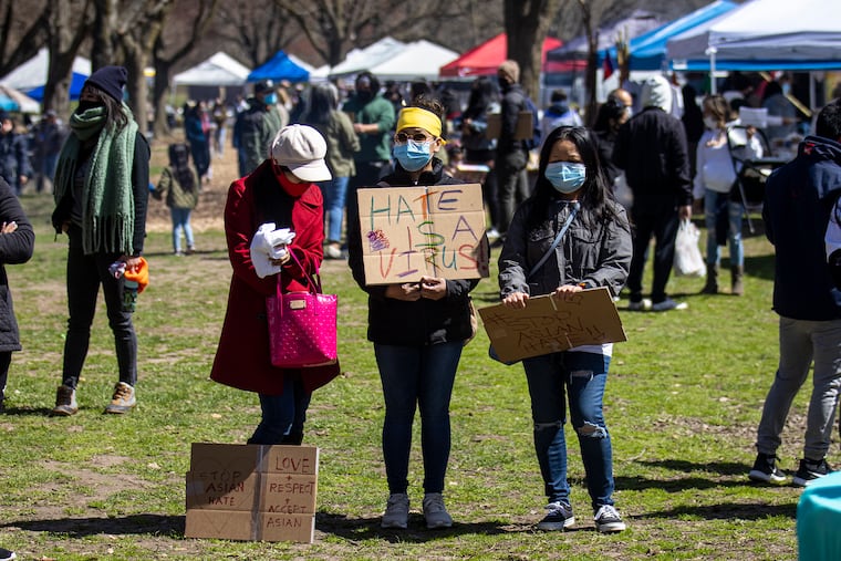 Thea Sem of North Philadelphia holds a sign reading, “Hate is a Virus,” during the Stop Anti Asian Hate Vigil at FDR Park on April 3, 2021.