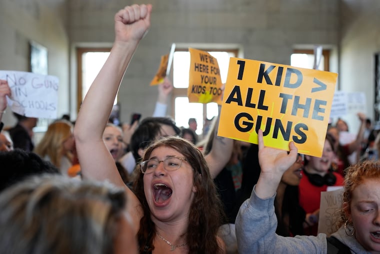 Emmie Wolf-Dubin, center, yells during a protest outside the House chamber after legislation passed that would allow some teachers to be armed in schools during a legislative session on Tuesday in Nashville, Tenn.