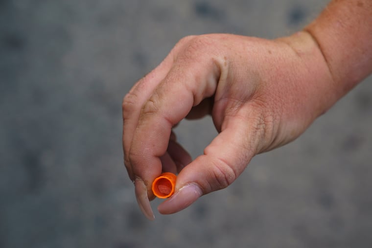 A woman holds a container with Crystal Meth in it, near Kensington Ave. and Allegheny Ave. a street corner known to be at the center of the heroin epidemic, in Philadelphia, September 28, 2019.