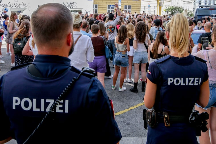 Police officers stand near a gathering of Taylor Swift fans in Vienna on Friday, Aug. 9, 2024.