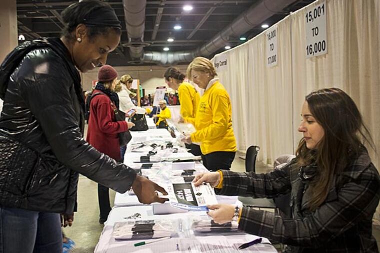 Brandi Dockett receives her marathon bib for the race this Sunday.
Philadelphia Convention Center. November 21, 2014. (Randi Fair/Staff Photographer)