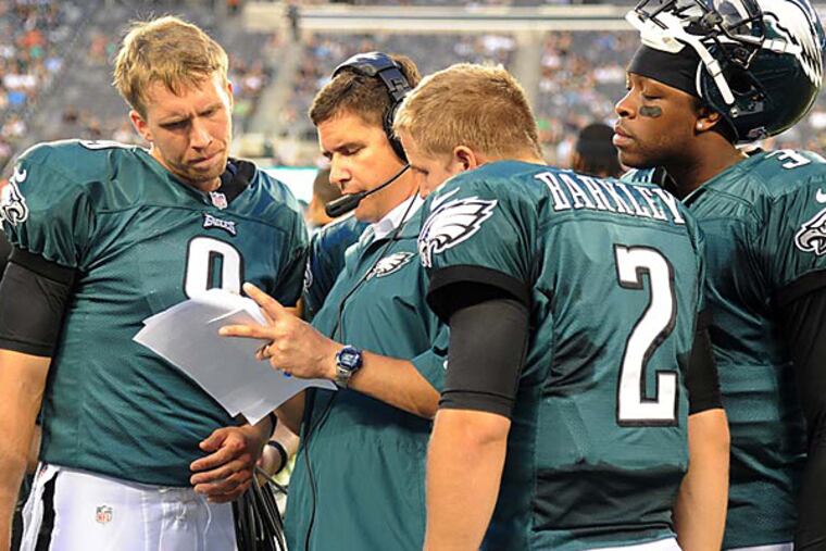 Bill Lazor talks with quarterbacks (from left) Nick Foles, Matt Barkley and Dennis Dixon. (Clem Murray/Staff file photo)