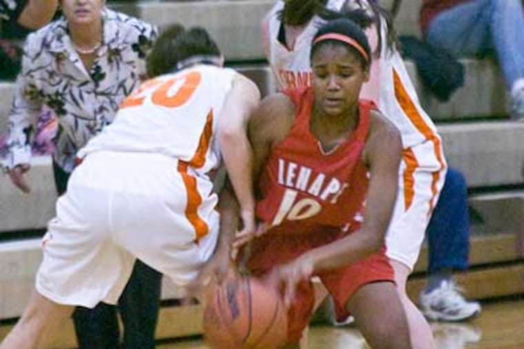 Lenape's Christina Foggie goes between two Cherokee players to score. (Ron Tarver / Staff Photographer)