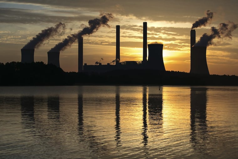 FILE – In this June 3, 2017, file photo, the coal-fired Plant Scherer, one of the nation's top carbon dioxide emitters, stands in the distance in Juliette, Ga. The Trump administration intends to roll back the centerpiece of former President Barack Obama’s efforts to slow global warming, seeking to ease restrictions on greenhouse gas emissions from coal-fired power plants. (AP Photo/Branden Camp, File)