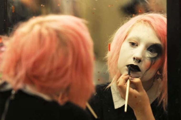 Toshi Salvino applies makeup before she and other actors start trying to scare up fun at Pennhurst Asylum. (BRADLEY C. BOWER / For The Inquirer)