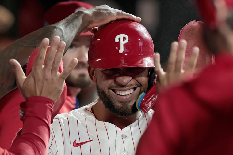 Edmundo Sosa celebrates with teammates after he scored in the eighth inning in the Phillies' comeback win on Wednesday.